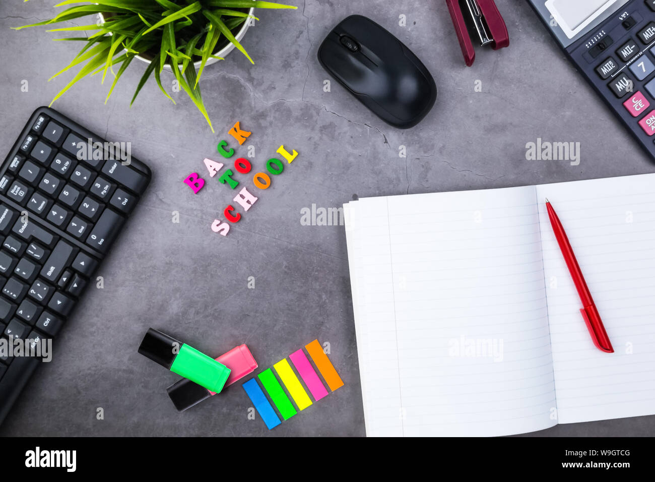 The layout of school supplies on a dark gray background. The view from the top. Back to school. Flat lay Stock Photo