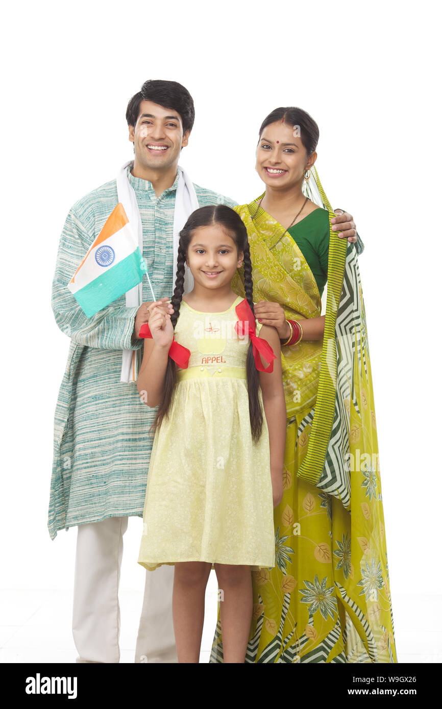 Rural family standing together and holding an Indian flag Stock Photo