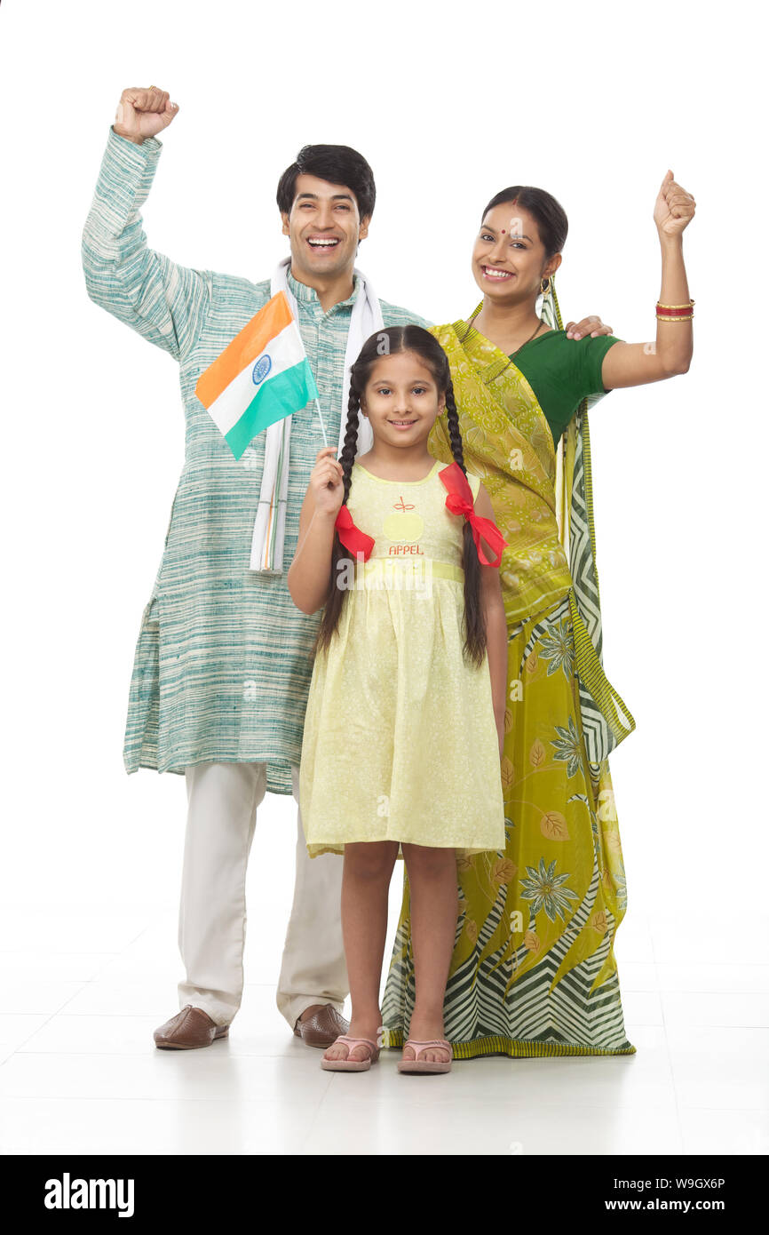 Rural family standing together and holding an Indian flag Stock Photo