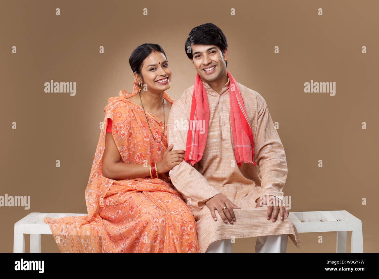 Rural couple sitting on bench and smiling Stock Photo - Alamy