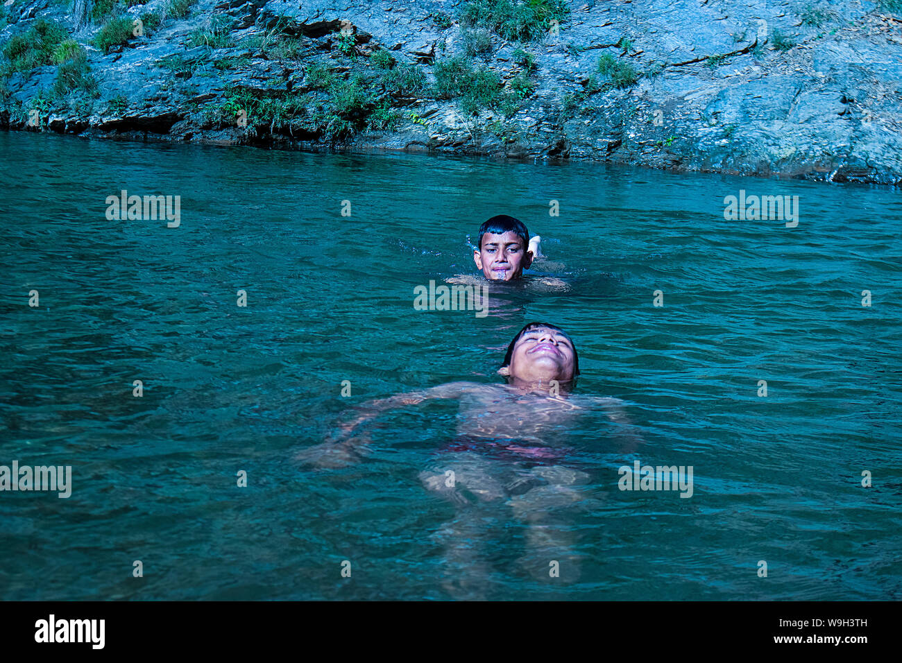 Himachal Pradesh, india - July 20th, 2019: Floating dead body of a drowned male children in River swimming pool murder. concept of safety Stock Photo