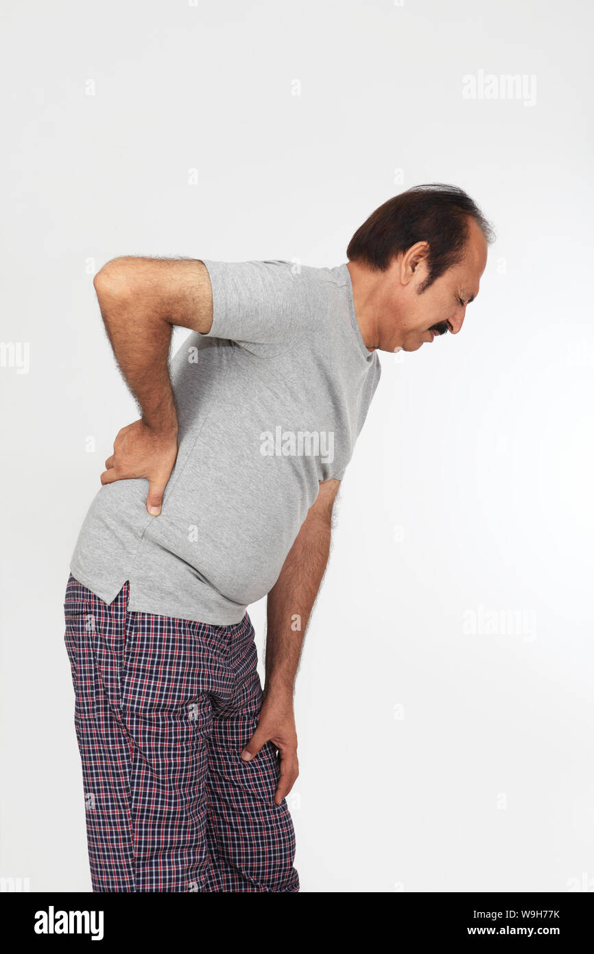Mature man suffering from lower back pain Stock Photo - Alamy