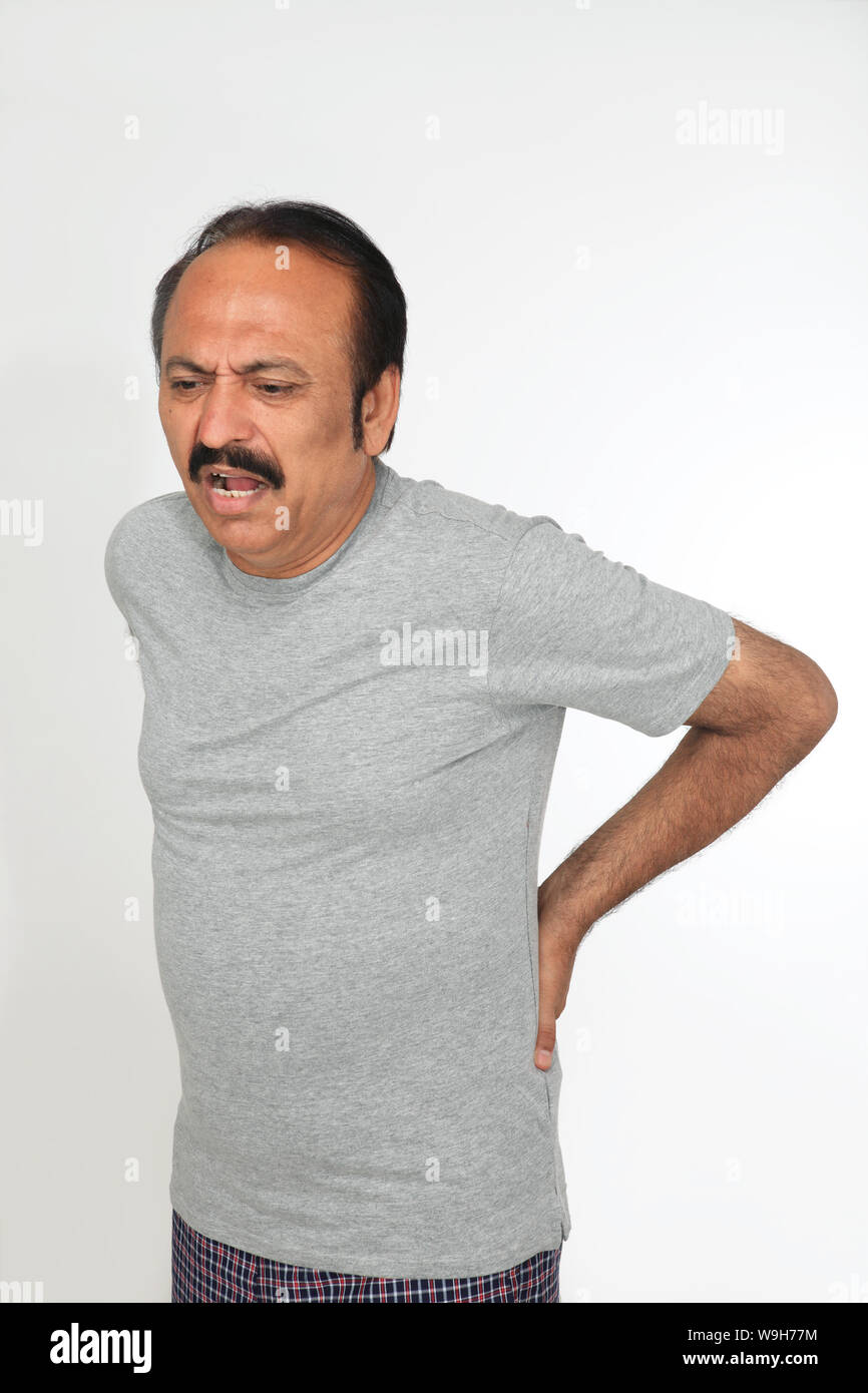 Mature man suffering from lower back pain Stock Photo - Alamy