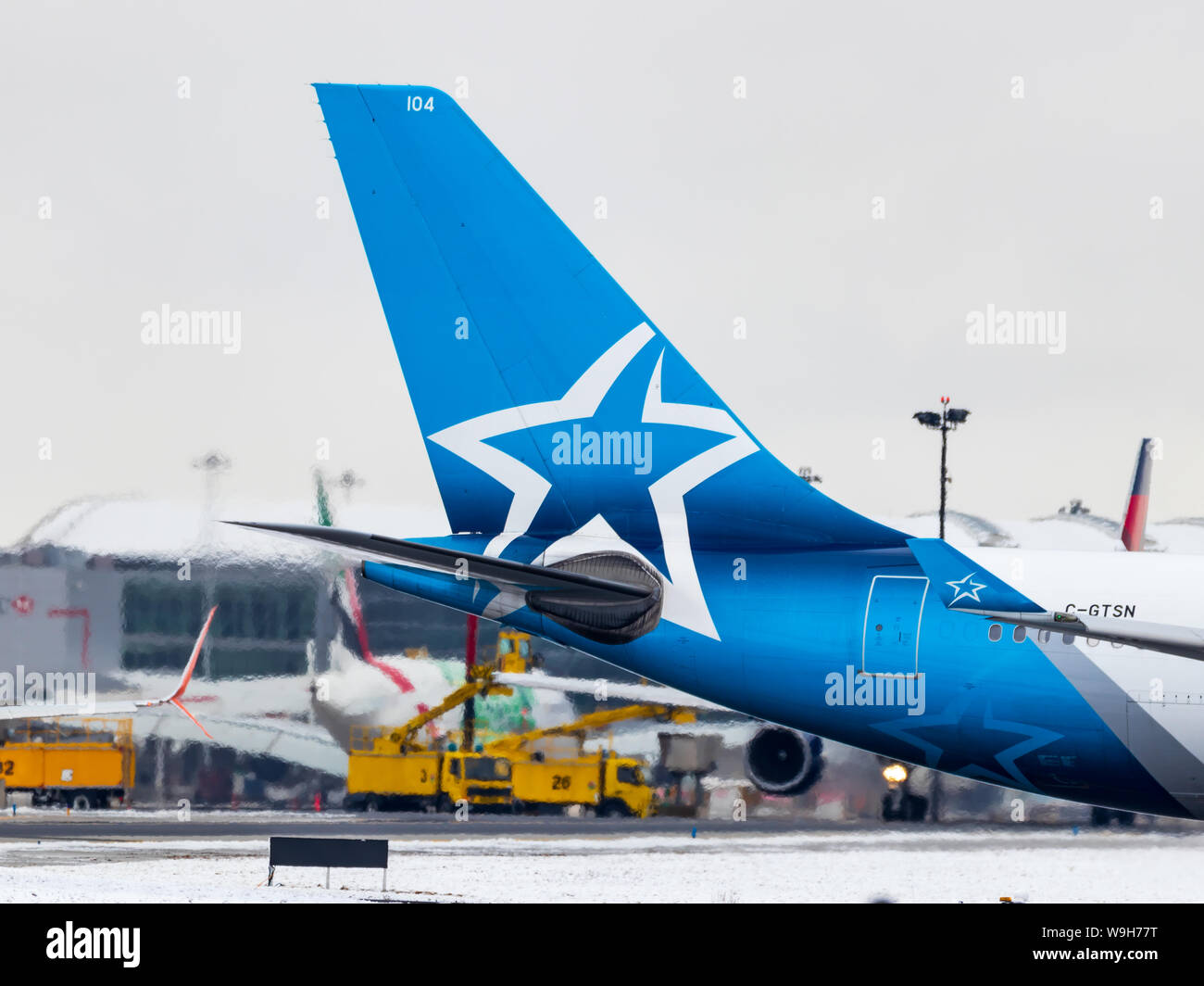 Air Transat Airbus A330 tail seen at Toronto Pearson Intl. Airport after de-icing on a snowy morning. Stock Photo