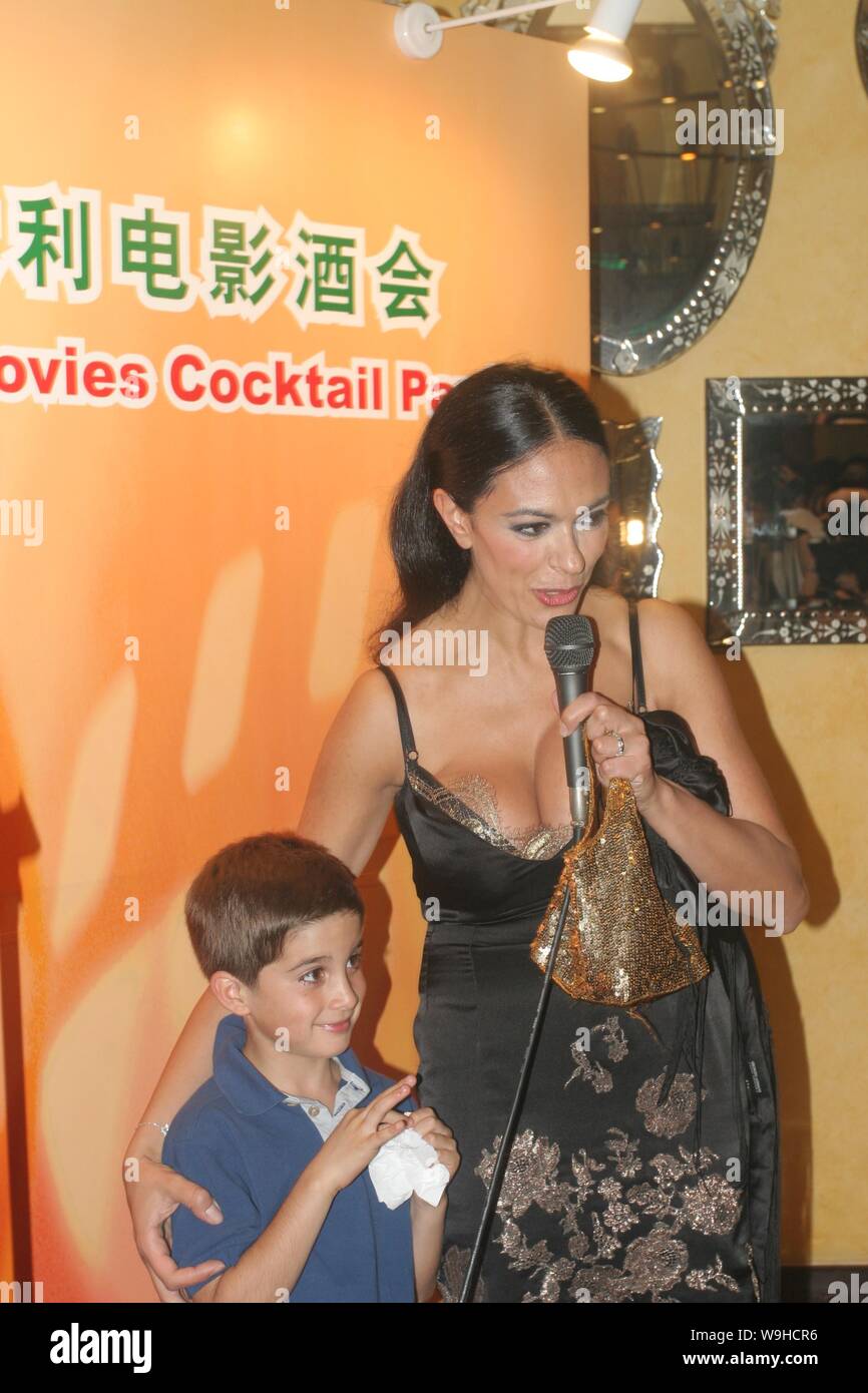 Italian actress Maria Grazia Cucinotta stays with a foreign child actor at a cocktail for Italian movies during the 10th Shanghai International Film F Stock Photo