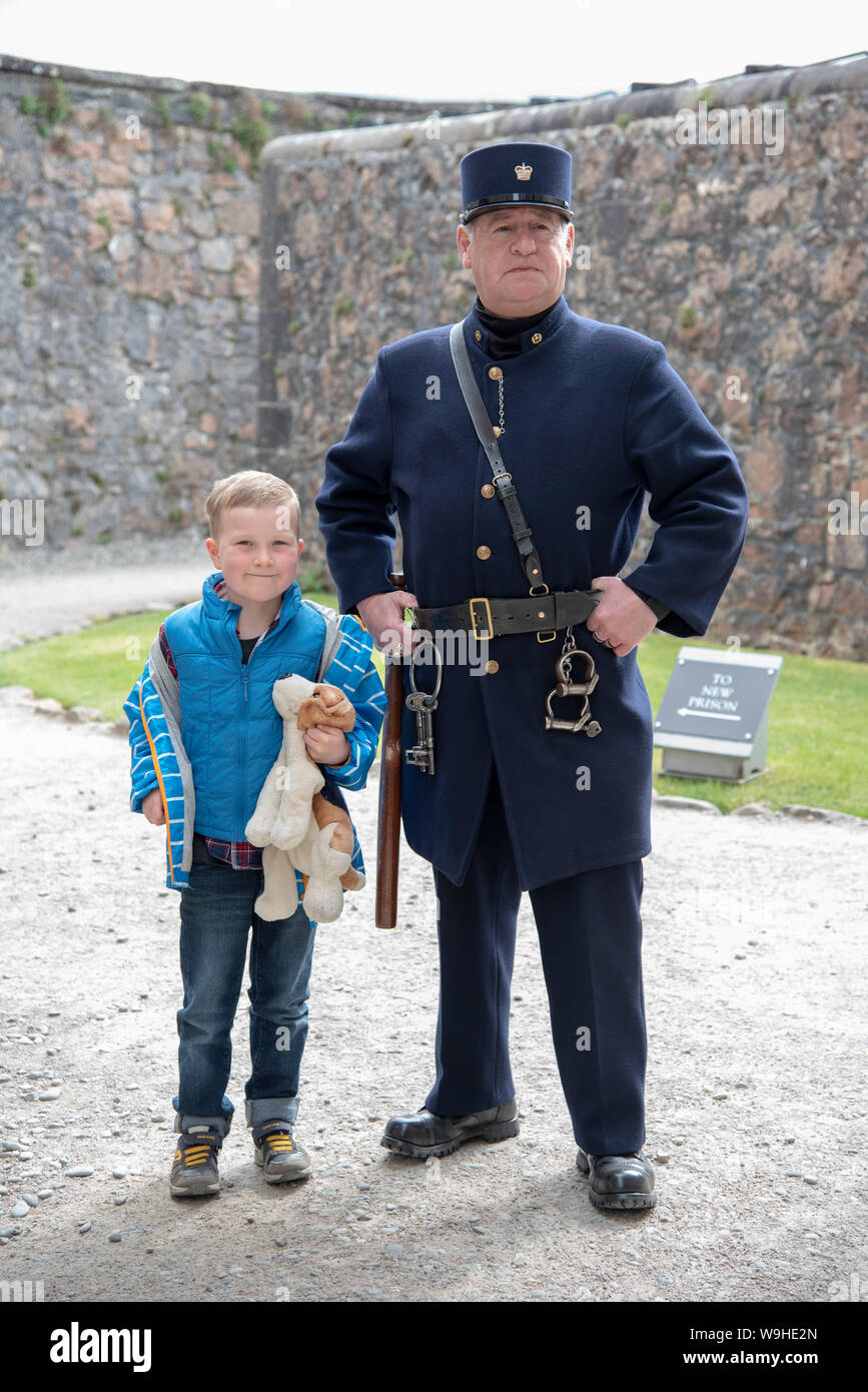 A costumed character at Inveraray jail poses with a young male visiter. Stock Photo
