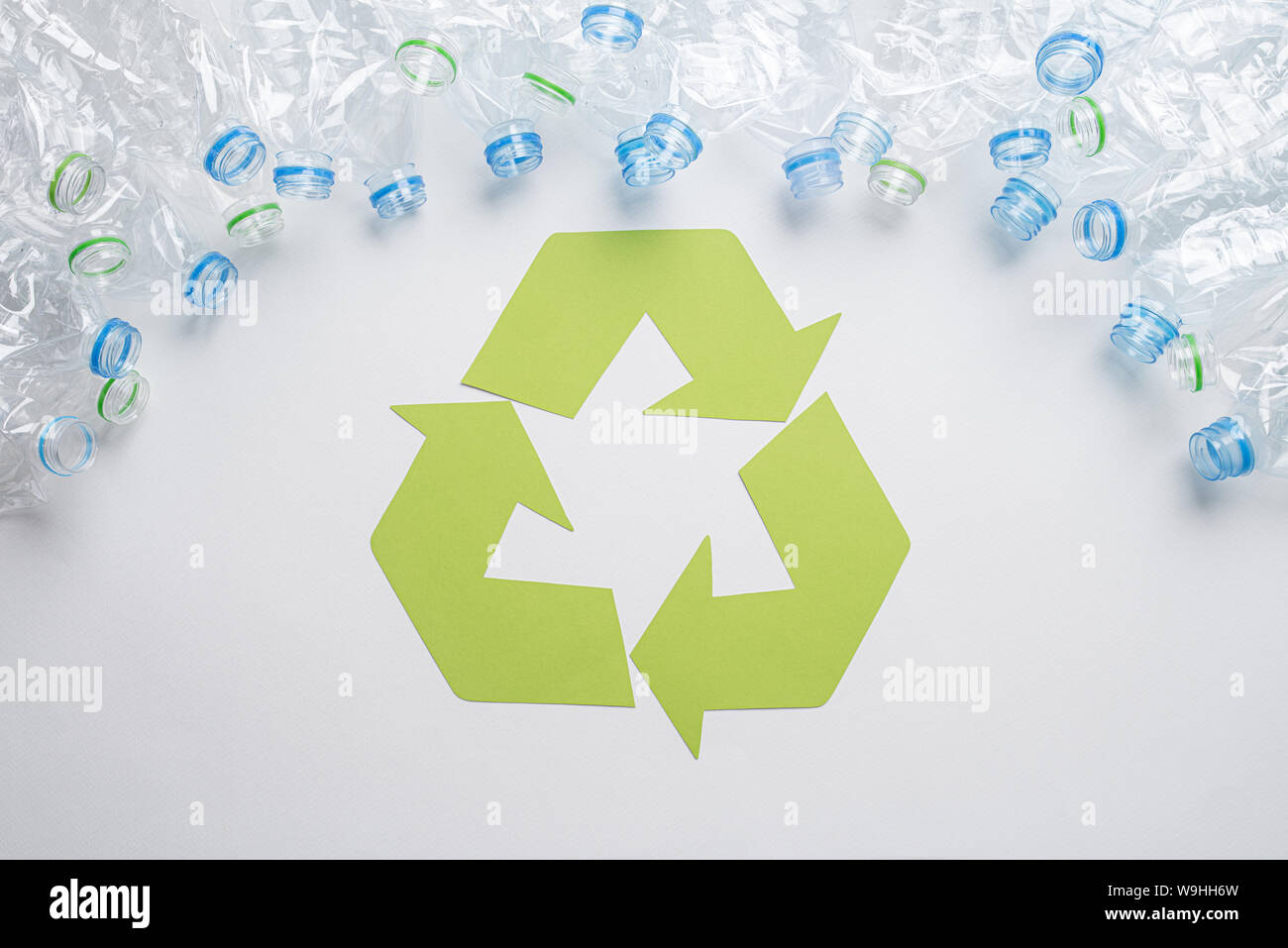 Frame of used plastic bottles with recycling symbol on wooden background. Recycle concept Stock Photo