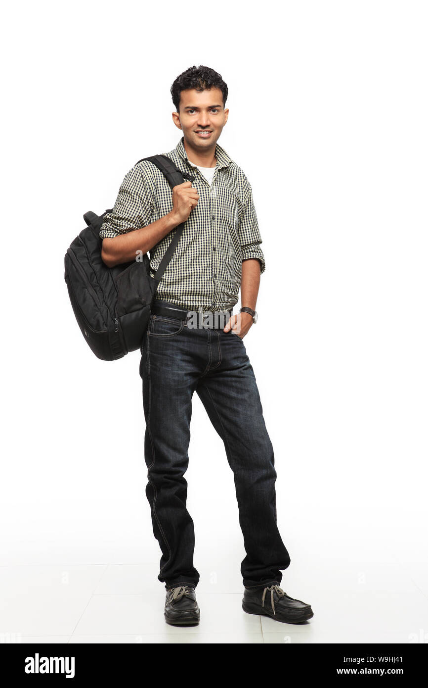 Young man standing with backpack Stock Photo - Alamy
