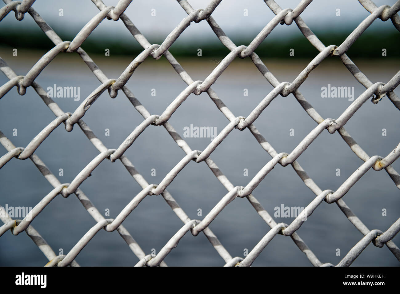Mesh cage fence with wire behind, marine concept Stock Photo Alamy