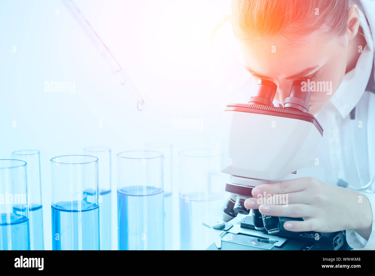 Science research lap chemical test drop with scientist usign microscope overaly Stock Photo