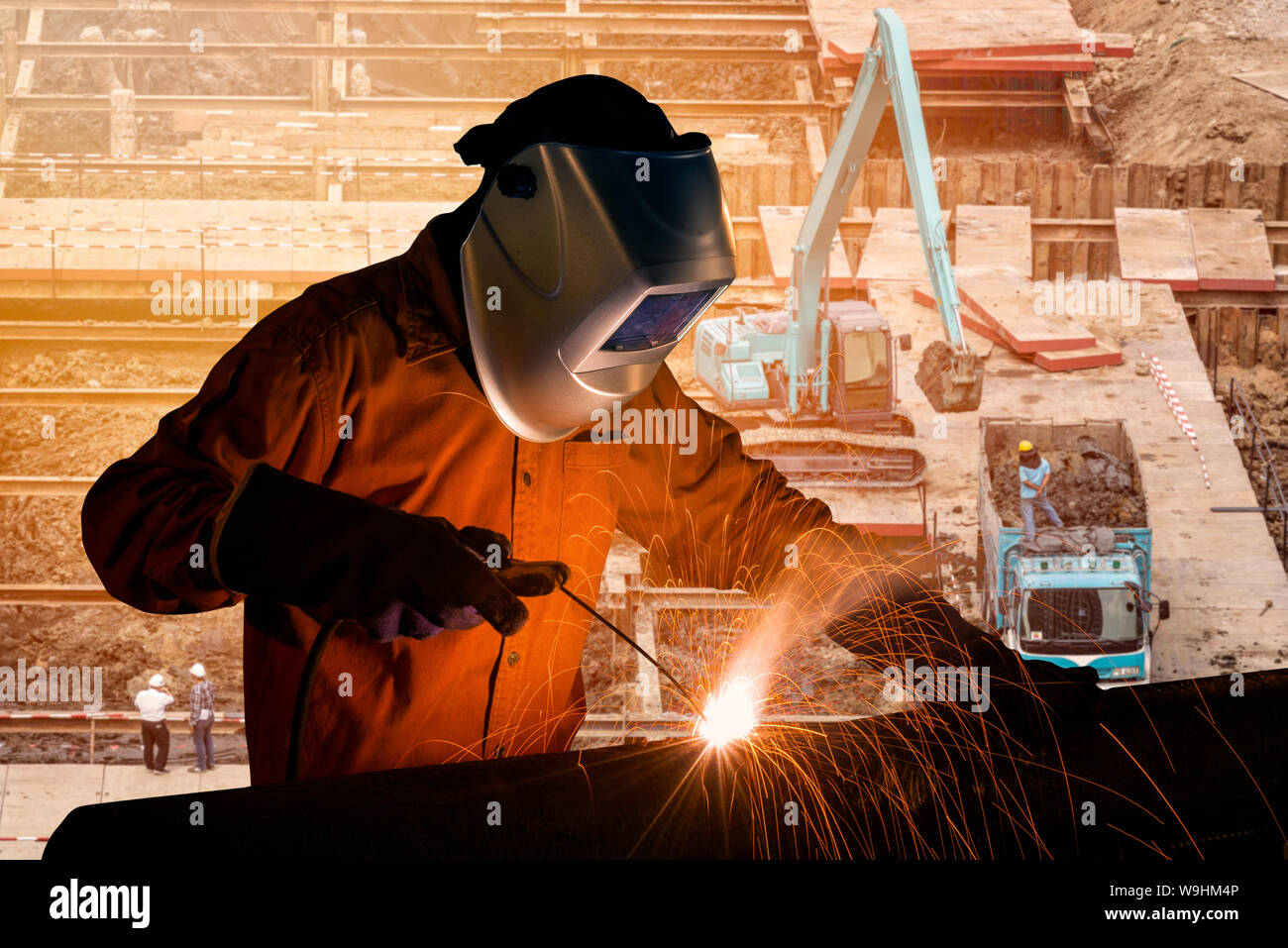 Welding worker welding steel structure with construction crane and