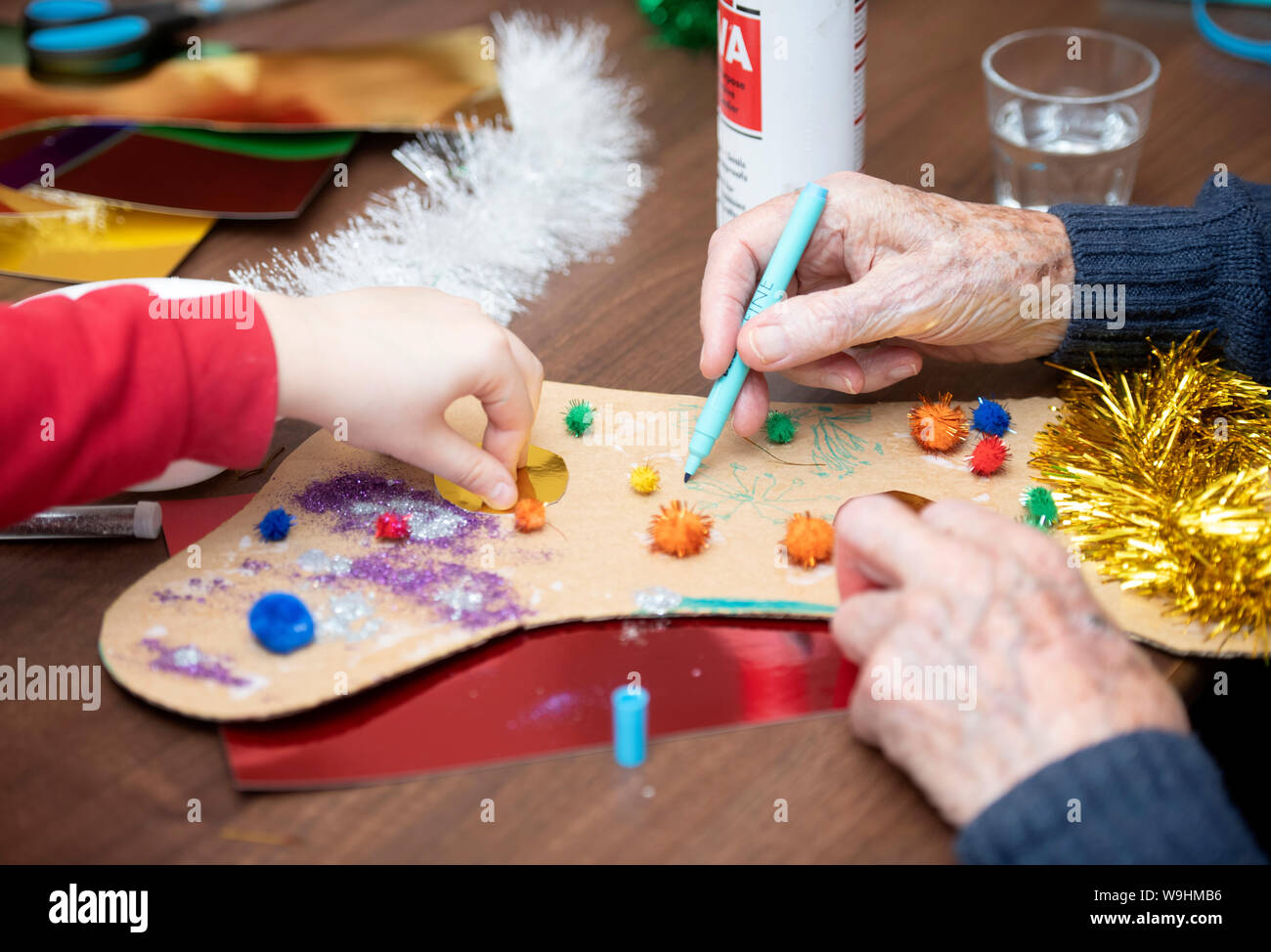 Schoolchildren in the Bristol area visit care homes to make Christmas decorations with residents in a scheme organised by the charity Alive Activies Stock Photo