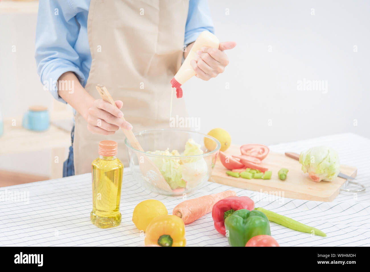 Young asian woman prepare healthy food salad at home for Healthy and dieting. Stock Photo