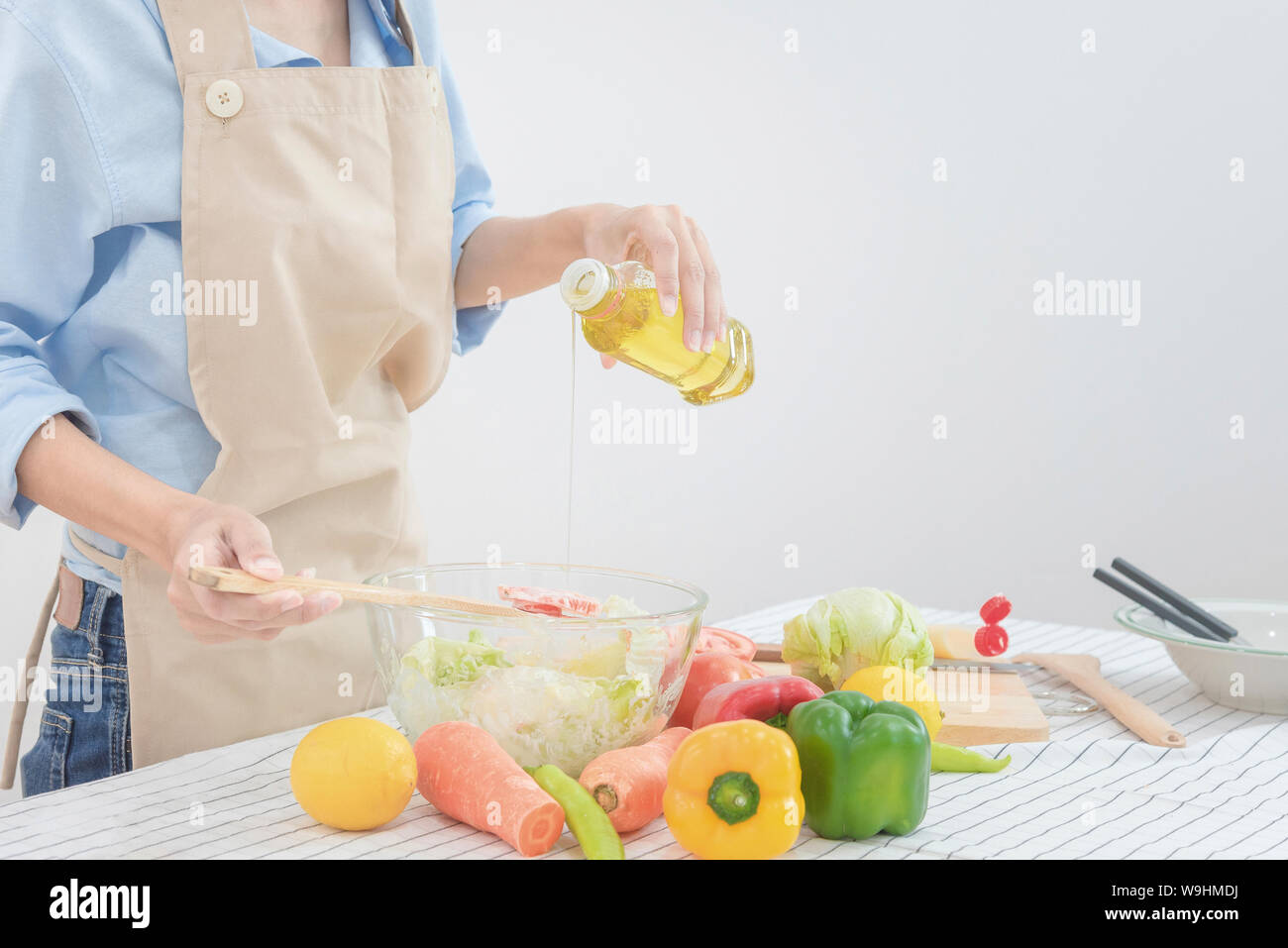 Young asian woman prepare healthy food salad at home for Healthy and dieting. Stock Photo