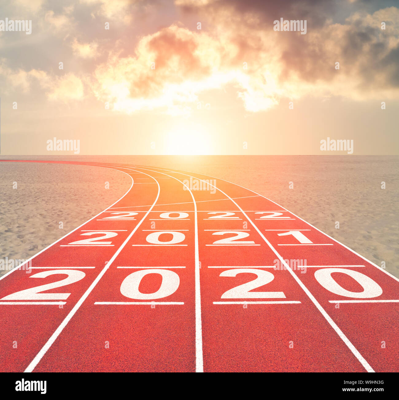 From 2020 into future concept with numbers on running track against sunset desert landscape Stock Photo