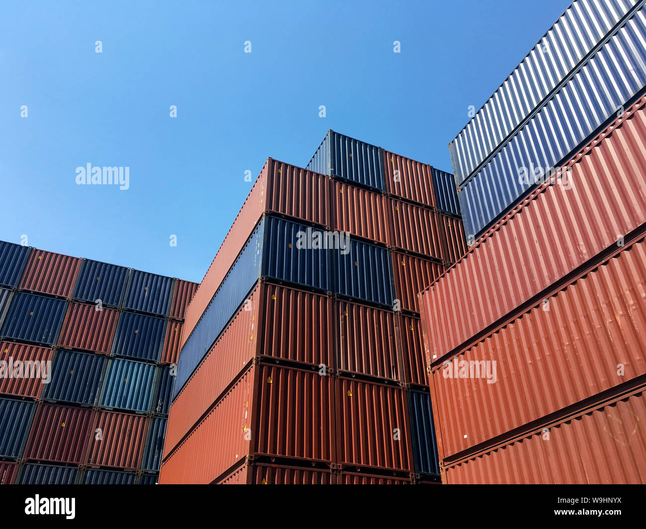 Colourful stack pattern of cargo shipping containers in shipping yard