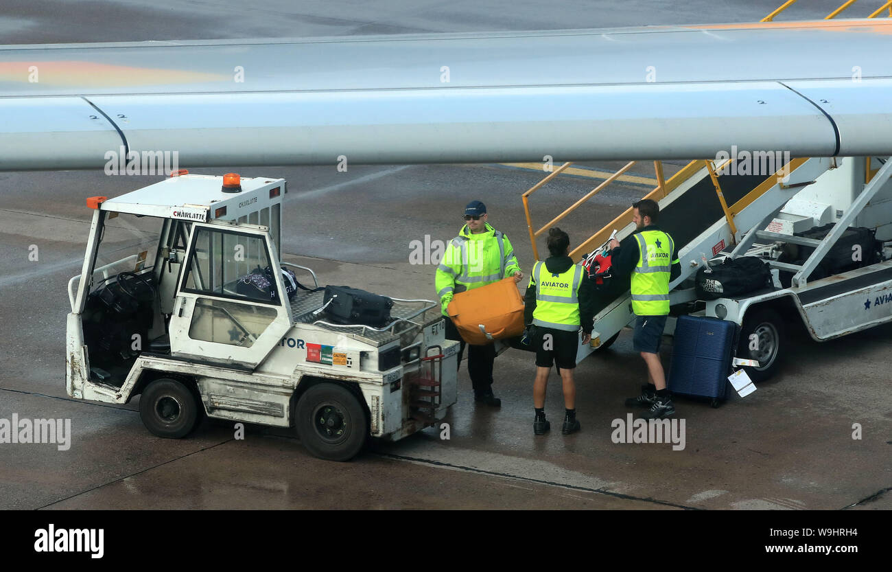 Baggage handlers on the runway at terminal one Manchester Airport Stock