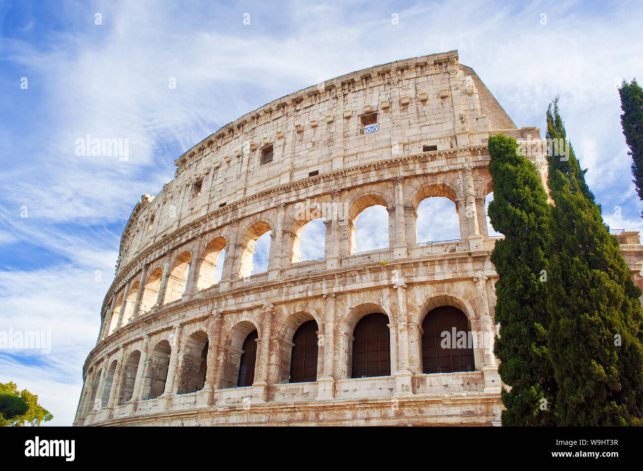 View of the top of amphitheater of Colosseum against blue sky with