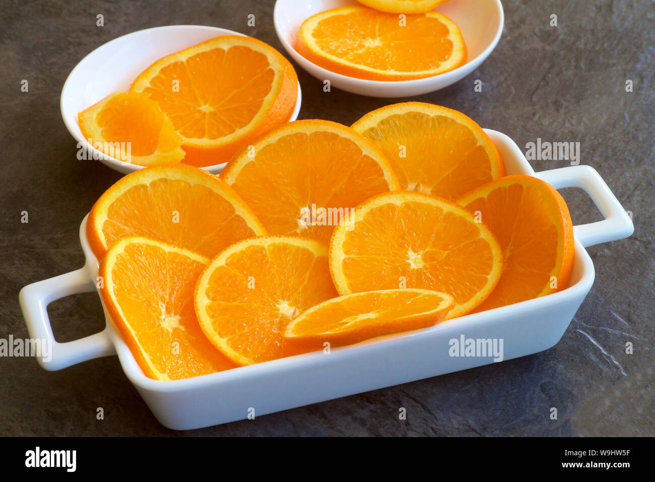 Orange slices on a white dish. Stock Photo