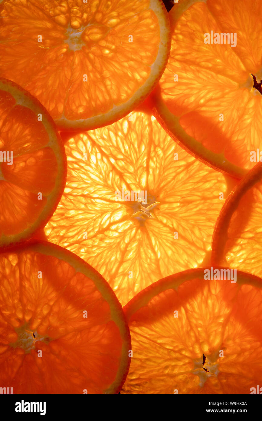 Colourful background of thinly sliced orange fruit. Stock Photo