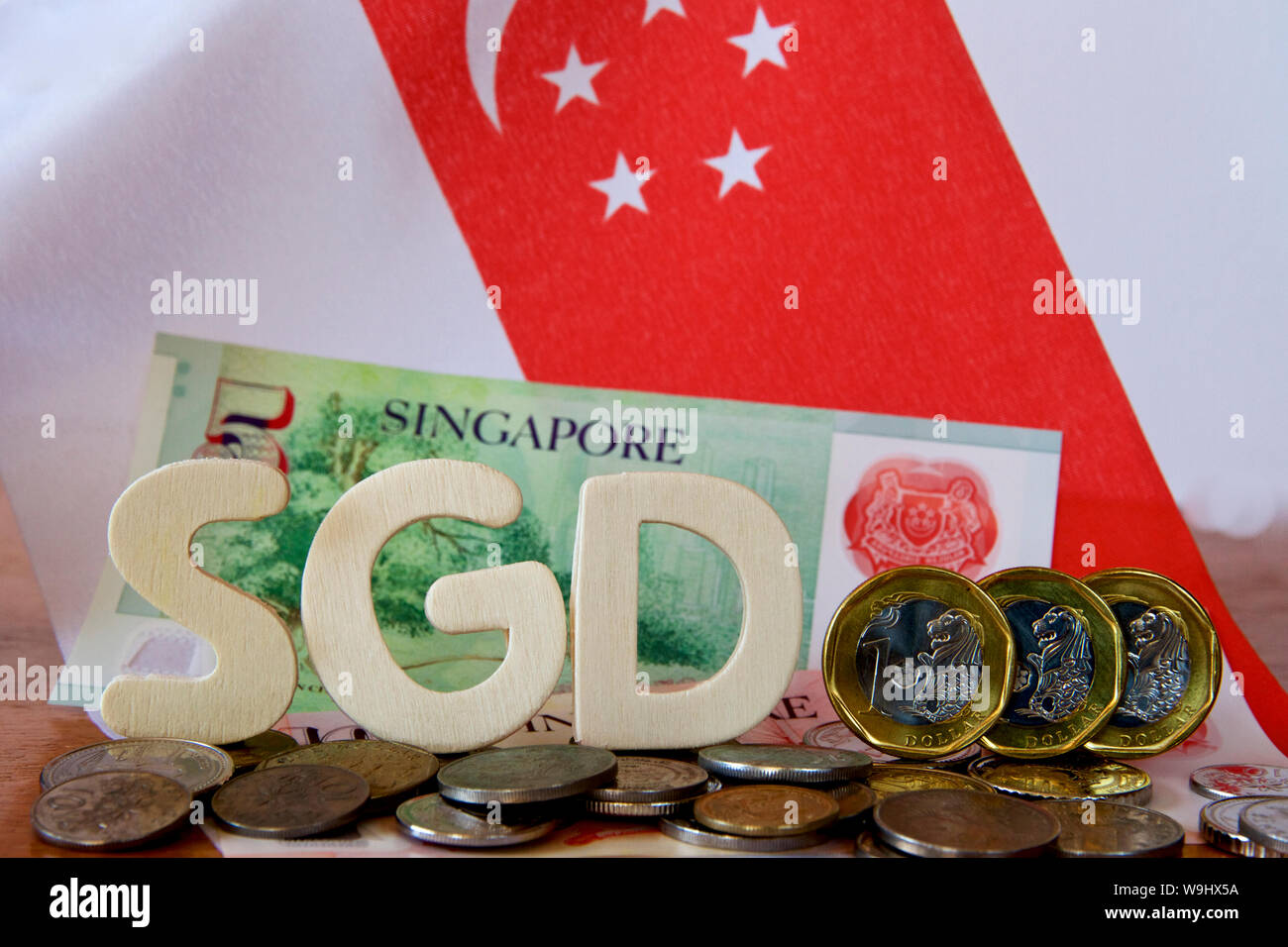 Singaporean dollars and coins with the Singapore flag. Stock Photo