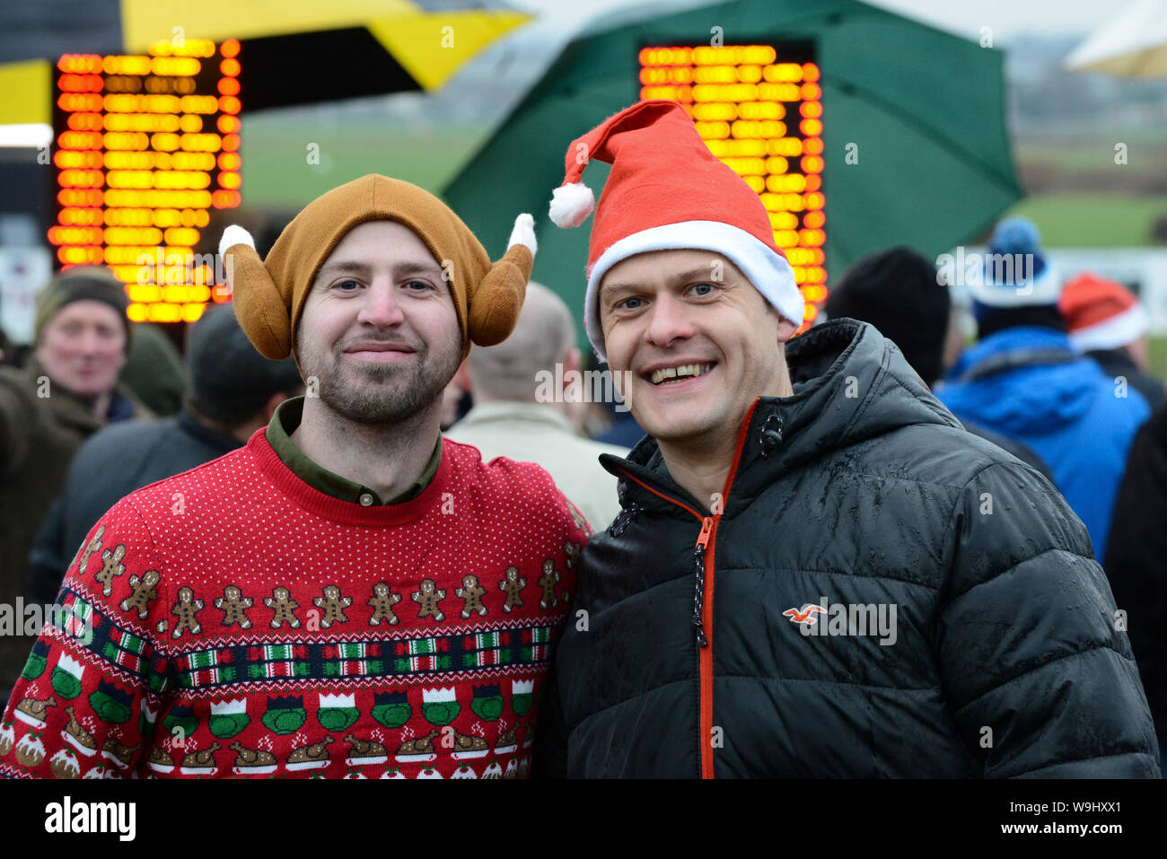 Christmas Jumper Raceday at Hereford Racecourse - Jay Morgan & Alex Simpson in their festive headgear. Stock Photo