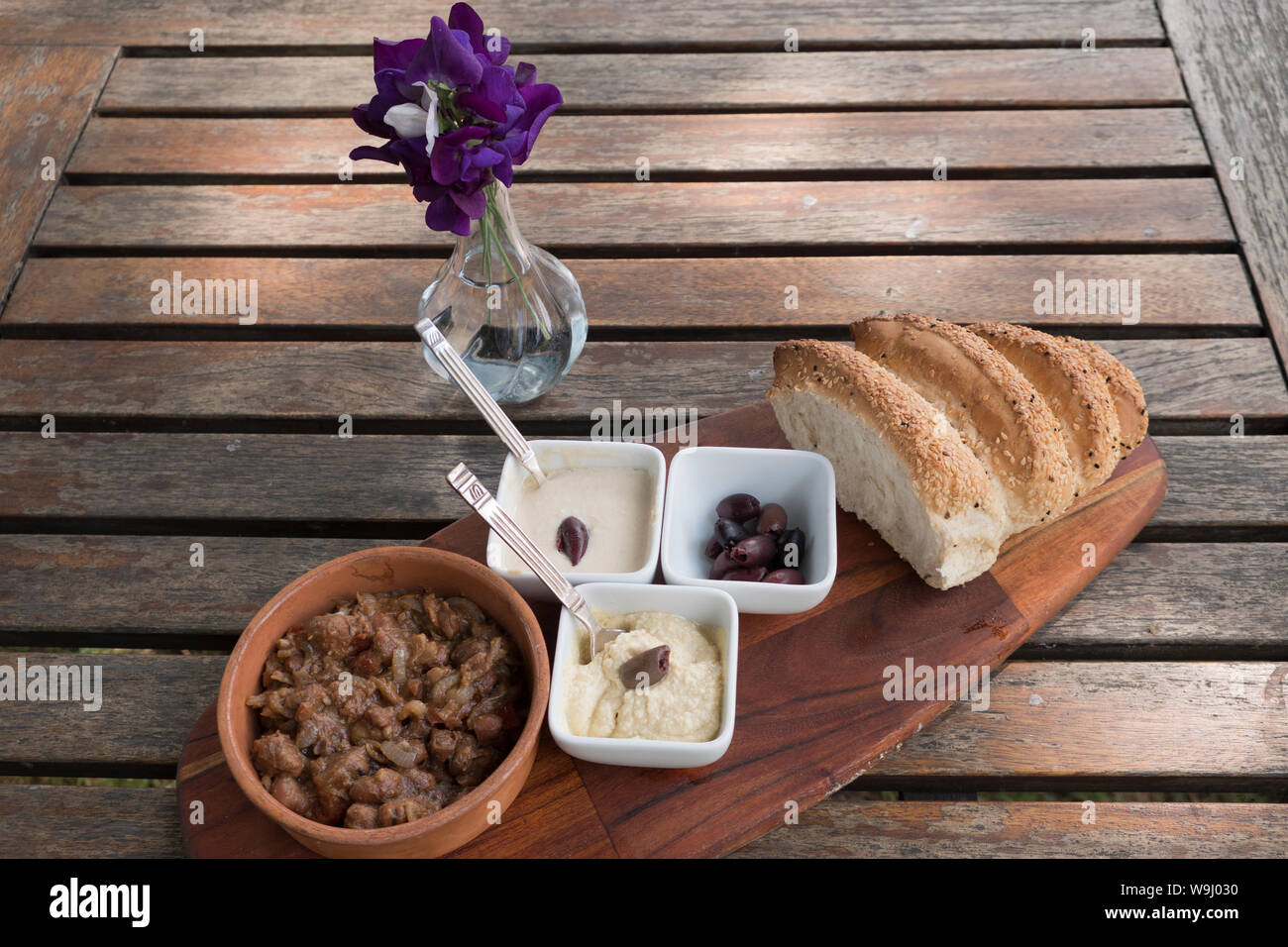 Vegan dishes of Fava Beans with dips and bread Stock Photo