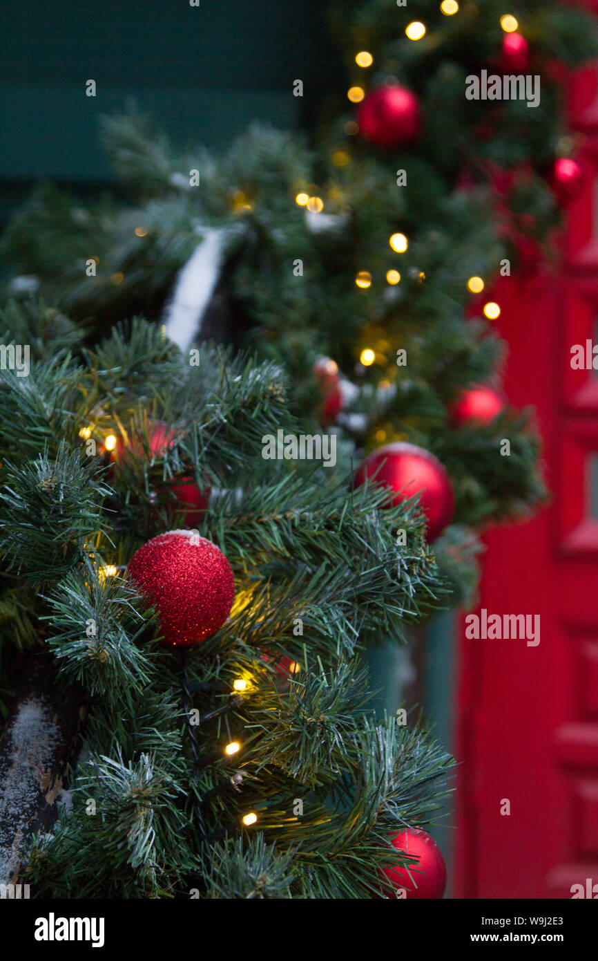 Focus On Christmas Tree With Red Ball Outside House Near The