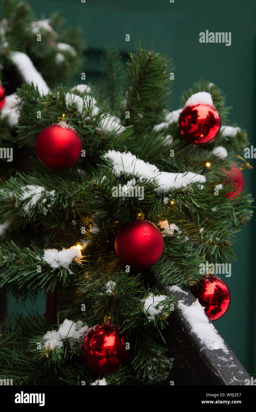 Focus On Christmas Tree With Red Ball Outside House Near The