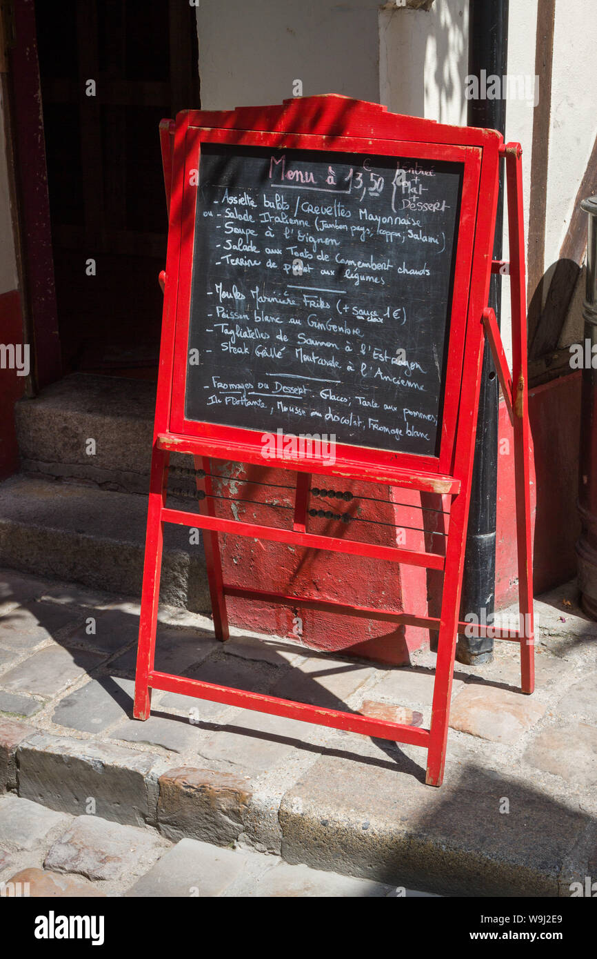 A red painted menu board with the menu hand-written in chalk in Honfleur, Normandy, France Stock Photo