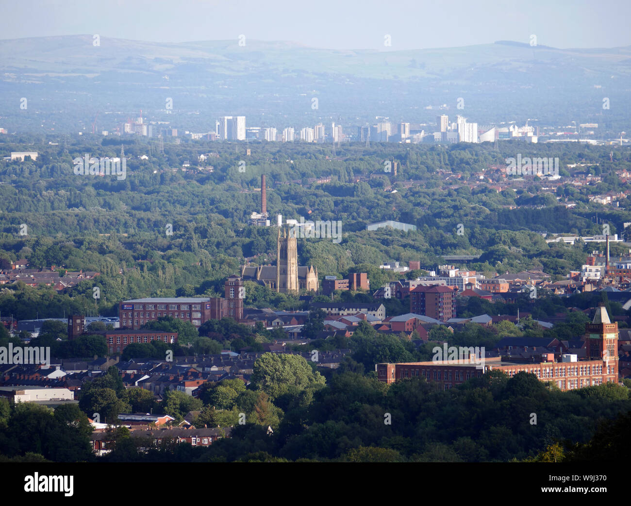 View looking over the town Bolton with the City of Manchester in the distance, Falcon Mill lower right, Bolton Parish Church central. photo DON TONGE Stock Photo