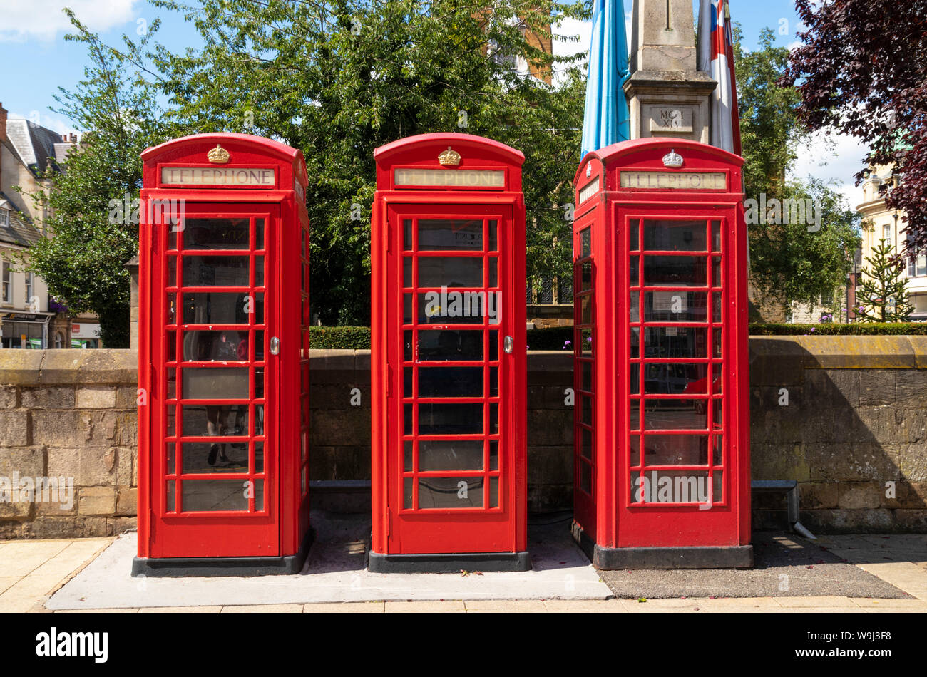 Red telephone boxes in a row three red phone boxes phone kiosk telephone boxes Northampton town centre Northamptonshire England UK GB Europe Stock Photo