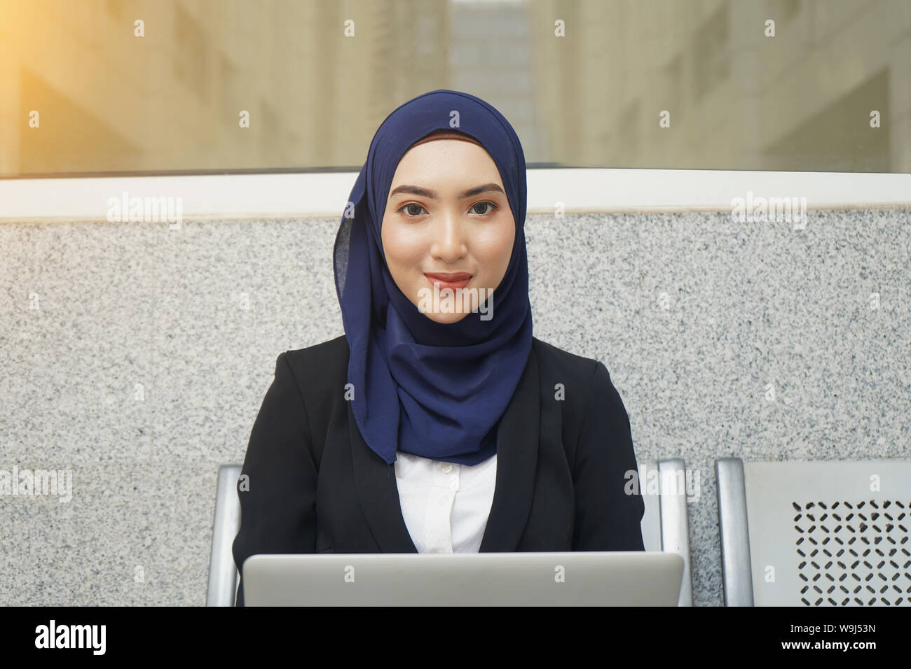Muslim business woman working on a laptop on airport Stock Photo - Alamy