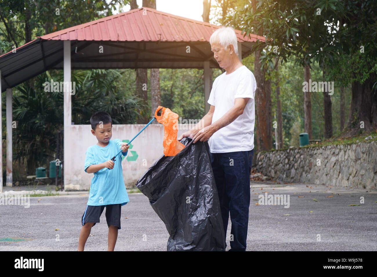 Child picking up trash hires stock photography and images Alamy
