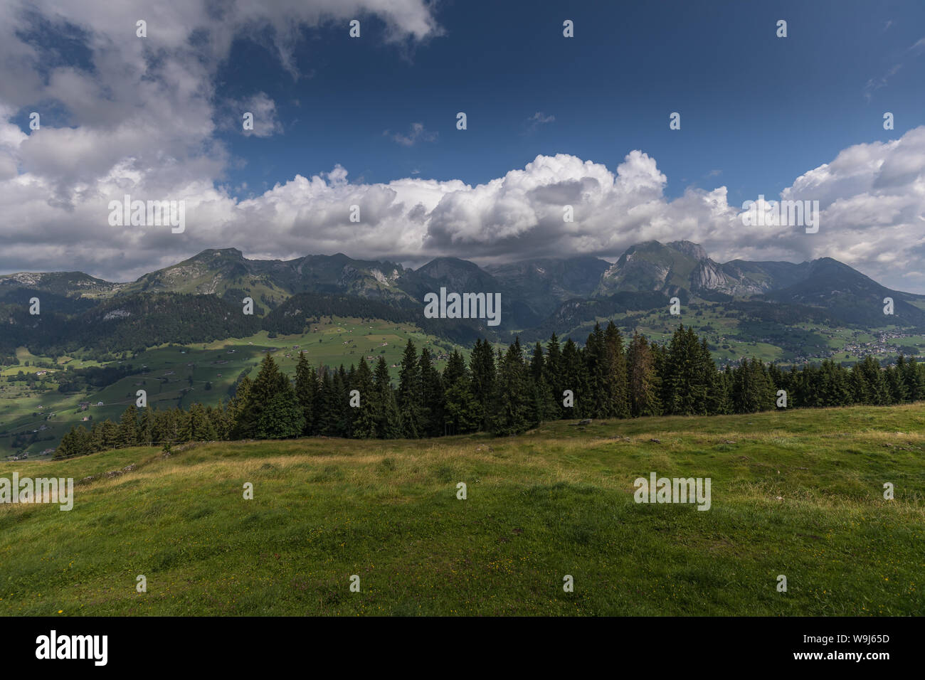 Hiking through swiss alps on a sunny day with blue sky near toggenburg ...