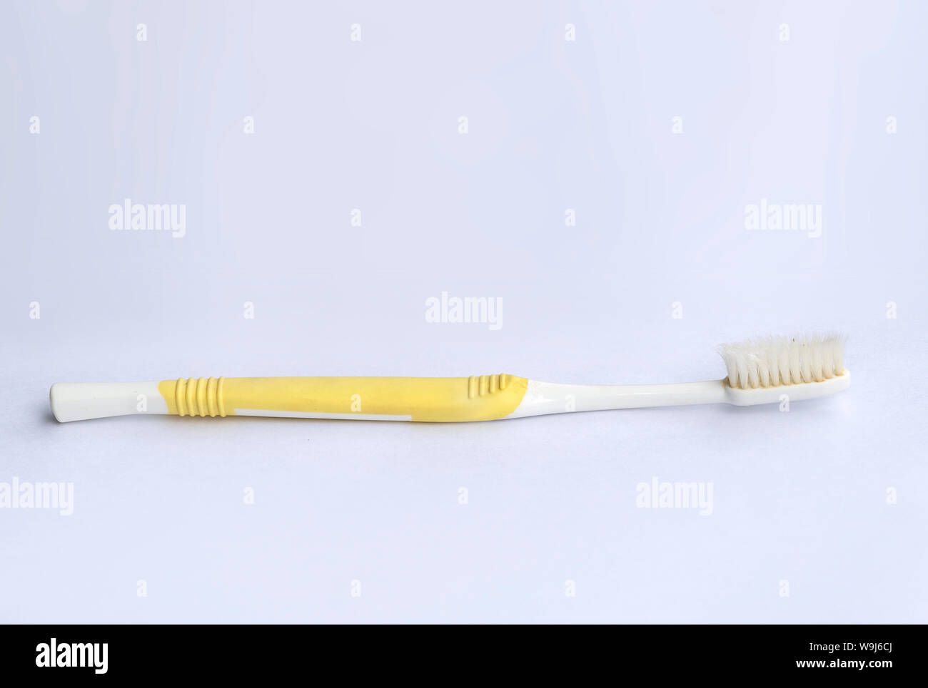 Used toothbrush on white background Stock Photo