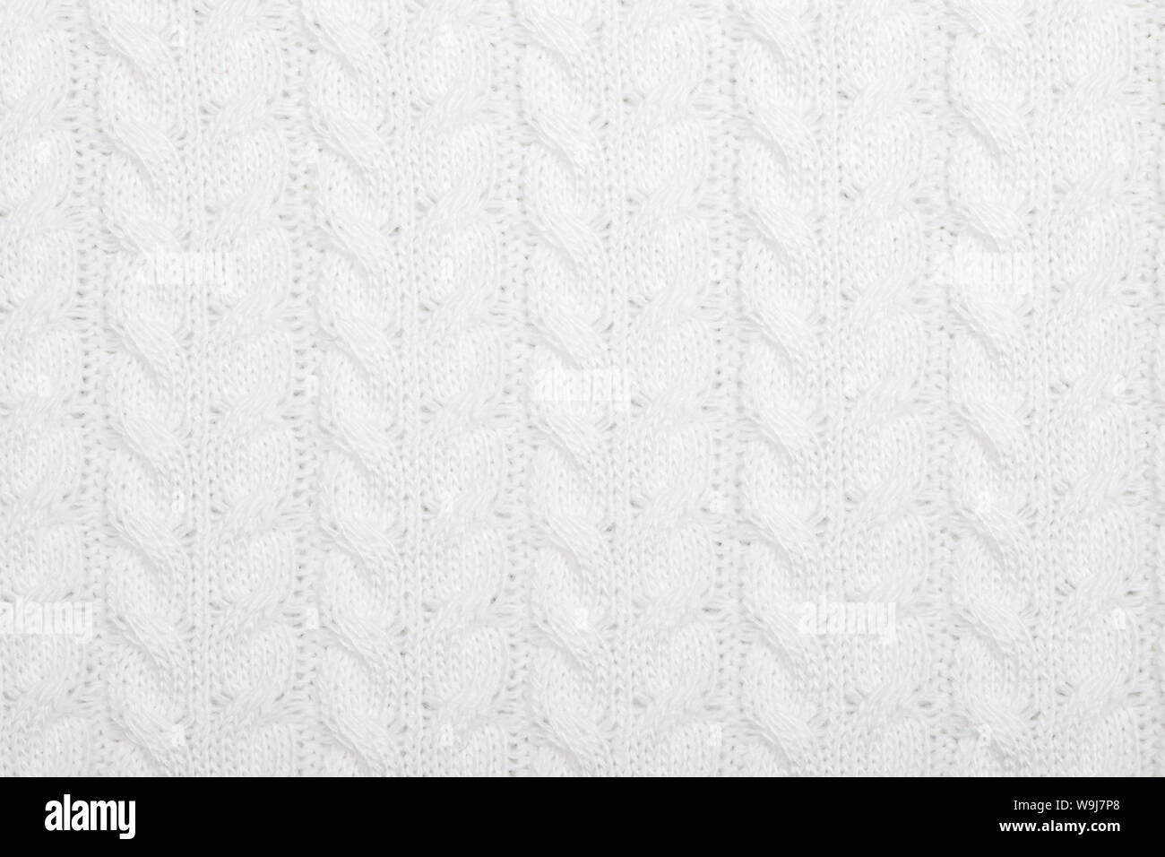 Real white knitted fabric with cable pattern textured background Stock Photo