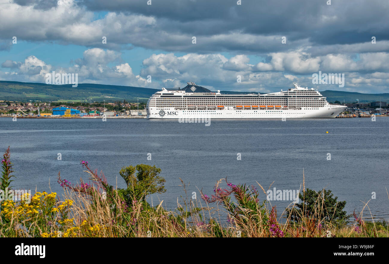 CROMARTY FIRTH ROSS AND CROMARTY SCOTLAND MSC ORCHESTRA A CRUISE LINER LYING OFF INVERGORDON WITH SUMMER SKIES AND FLOWERS Stock Photo
