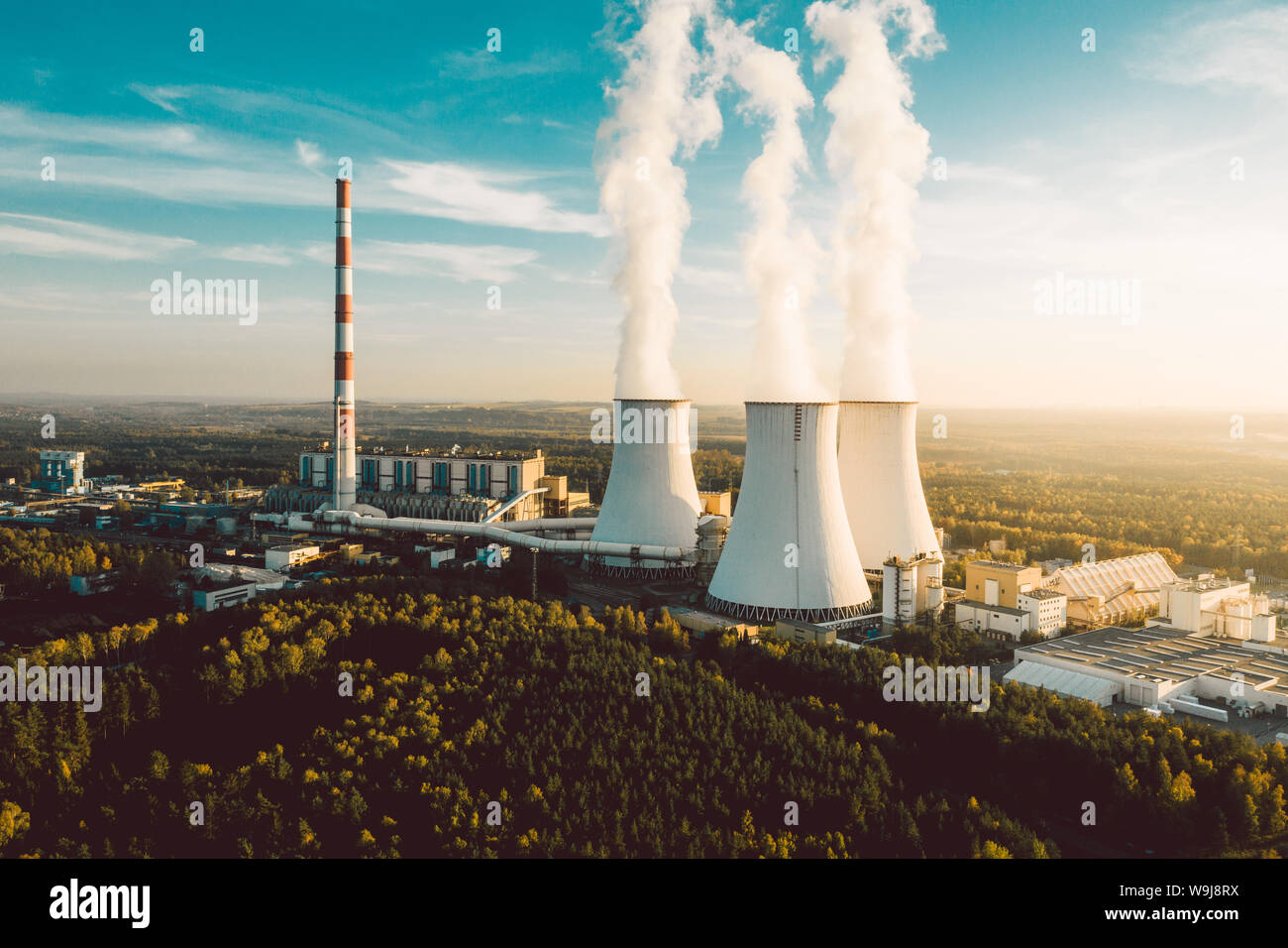 A Power plant with white smoke over it's chimneys Stock Photo - Alamy