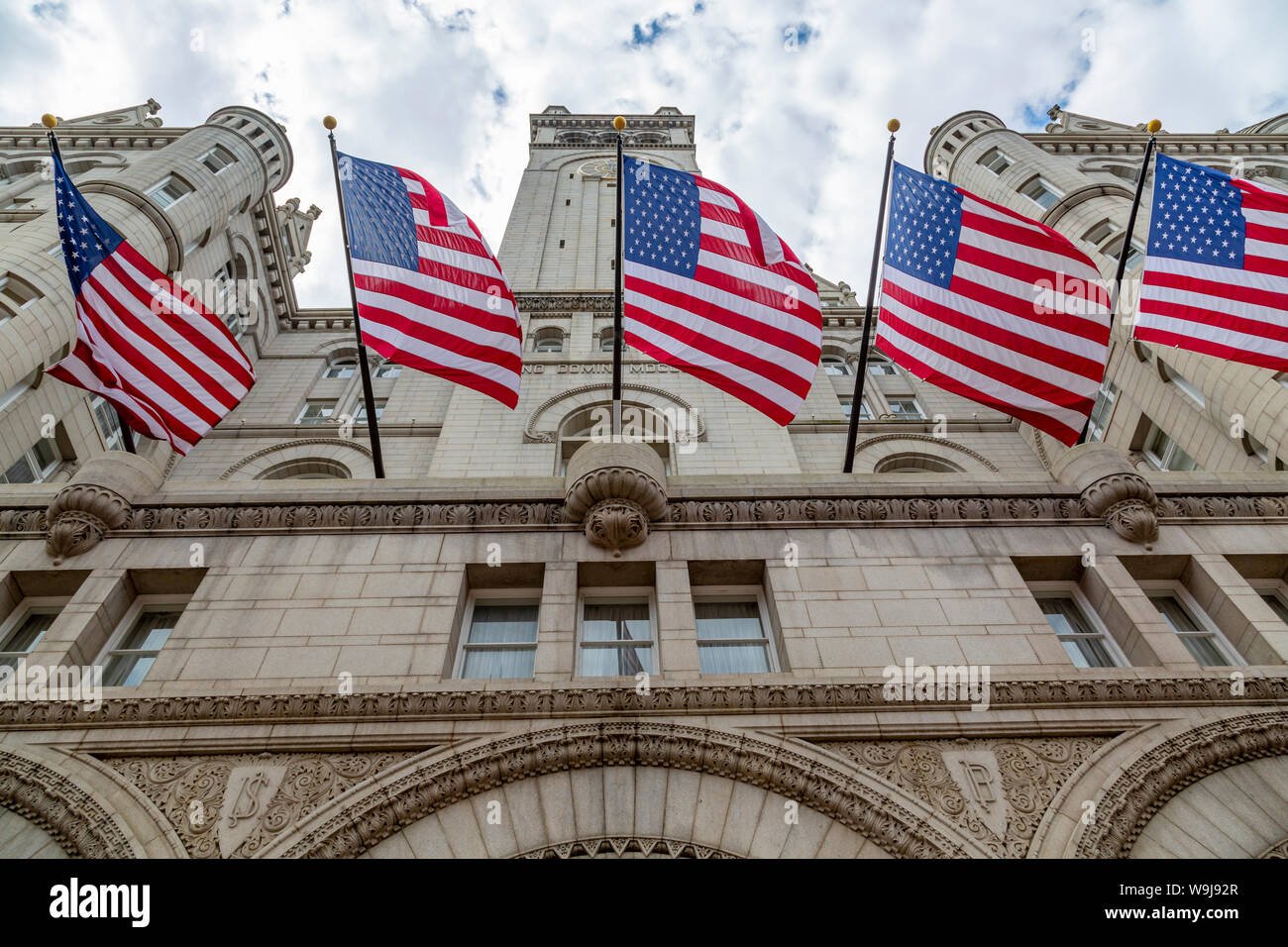 View of US flags in front of former Old Post Office Pavilion, Washington DC, District of Columbia, United States of America Stock Photo