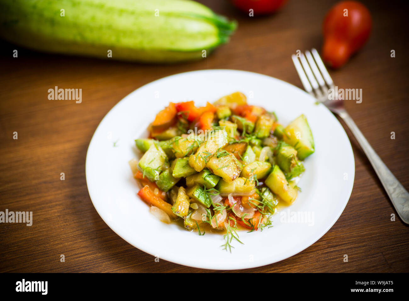 fried zucchini with red pepper, onions, tomatoes and other vegetables