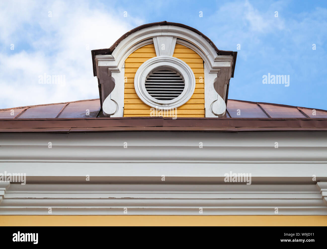Vintage attic ventilation window on a roof slope in decorative round