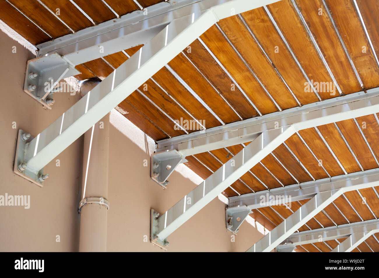 Wooden balcony floor mounted on cantilever beams, bottom view Stock Photo