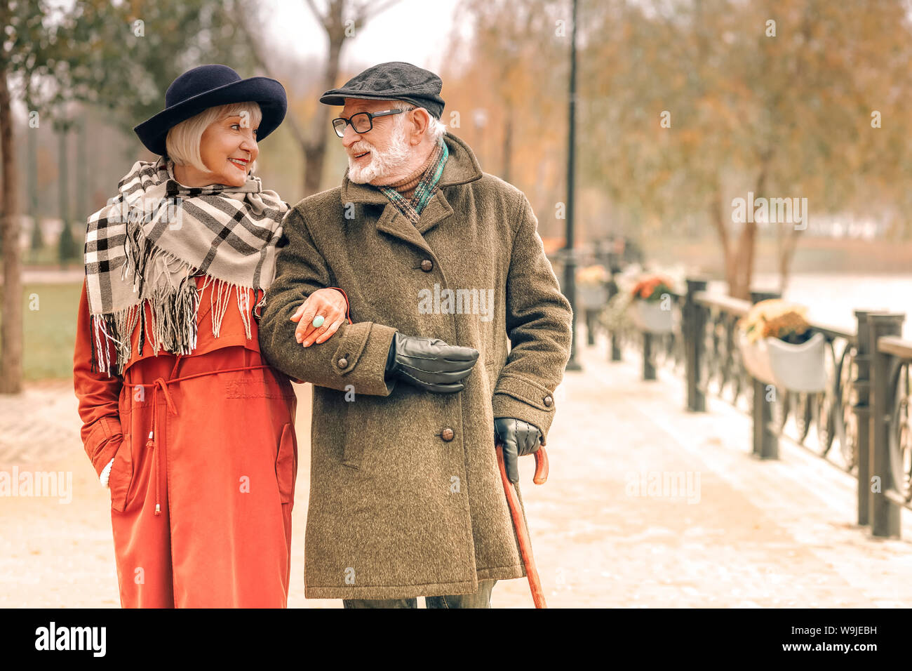 Elderly couple taking a walk in park Stock Photo