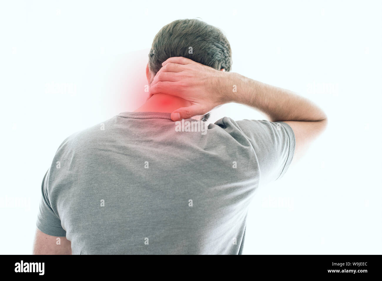 rear view of man suffering from neck pain Stock Photo