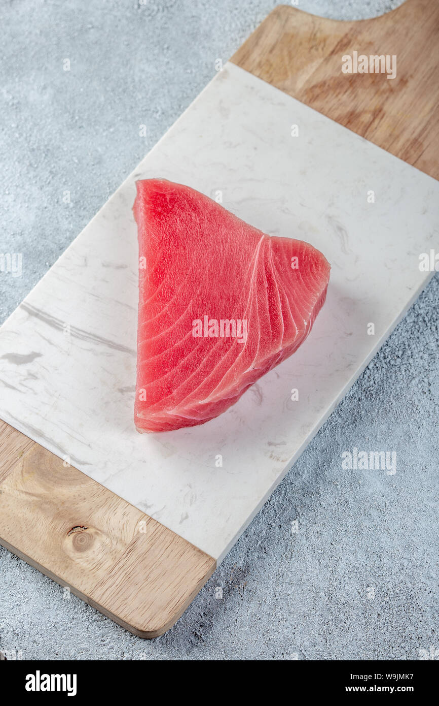Raw tuna steak on white concrete background Stock Photo