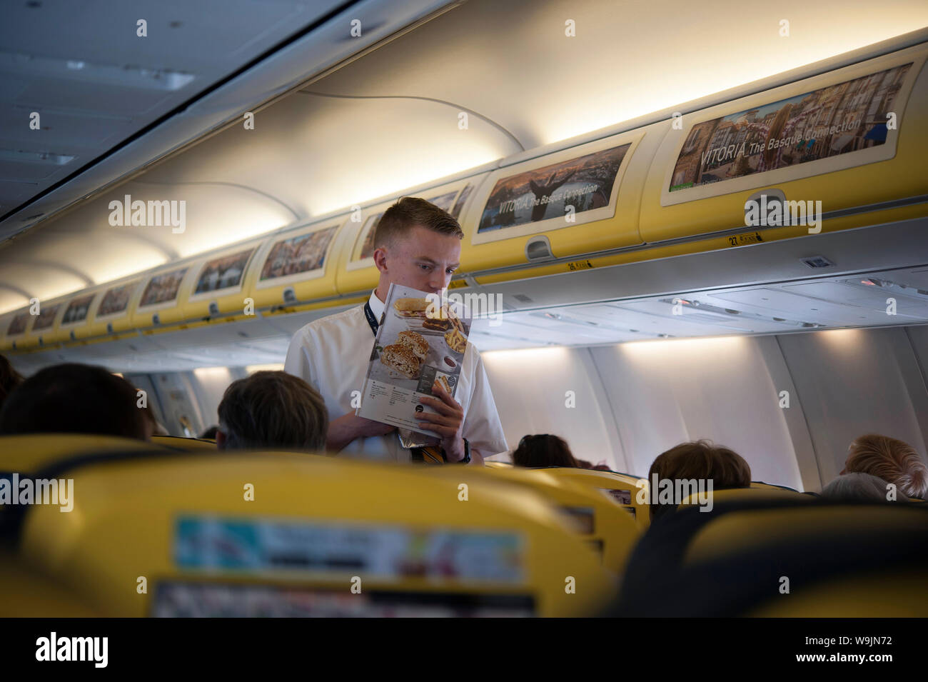 Ryanair steward selling wares, aircraft interior, Dublin Airport, Swords, Dublin, Ireland, Europe Stock Photo