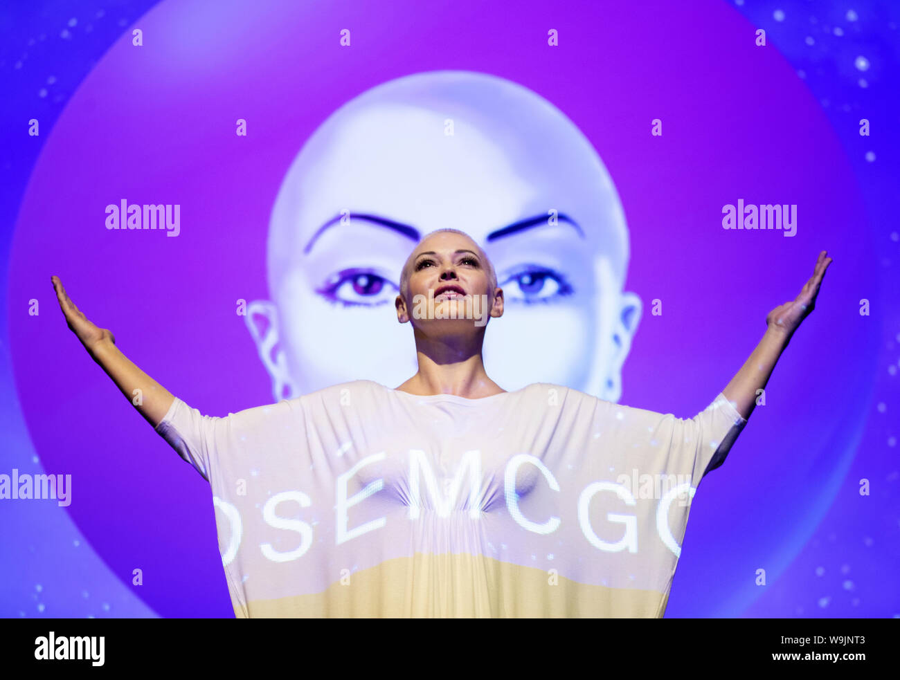 Actress and activist Rose McGowan on stage at the Assembly Hall, Edinburgh, with backdrop projections from her debut stage show Planet 9, which premieres on Thursday at the Edinburgh Festival. Stock Photo