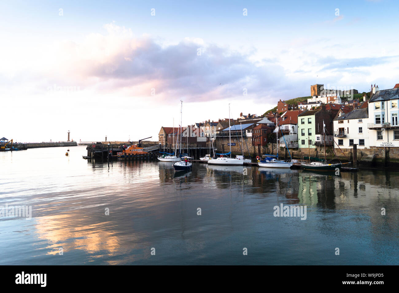A tranquil evening in Whitby Harbour showing the old town. Stock Photo