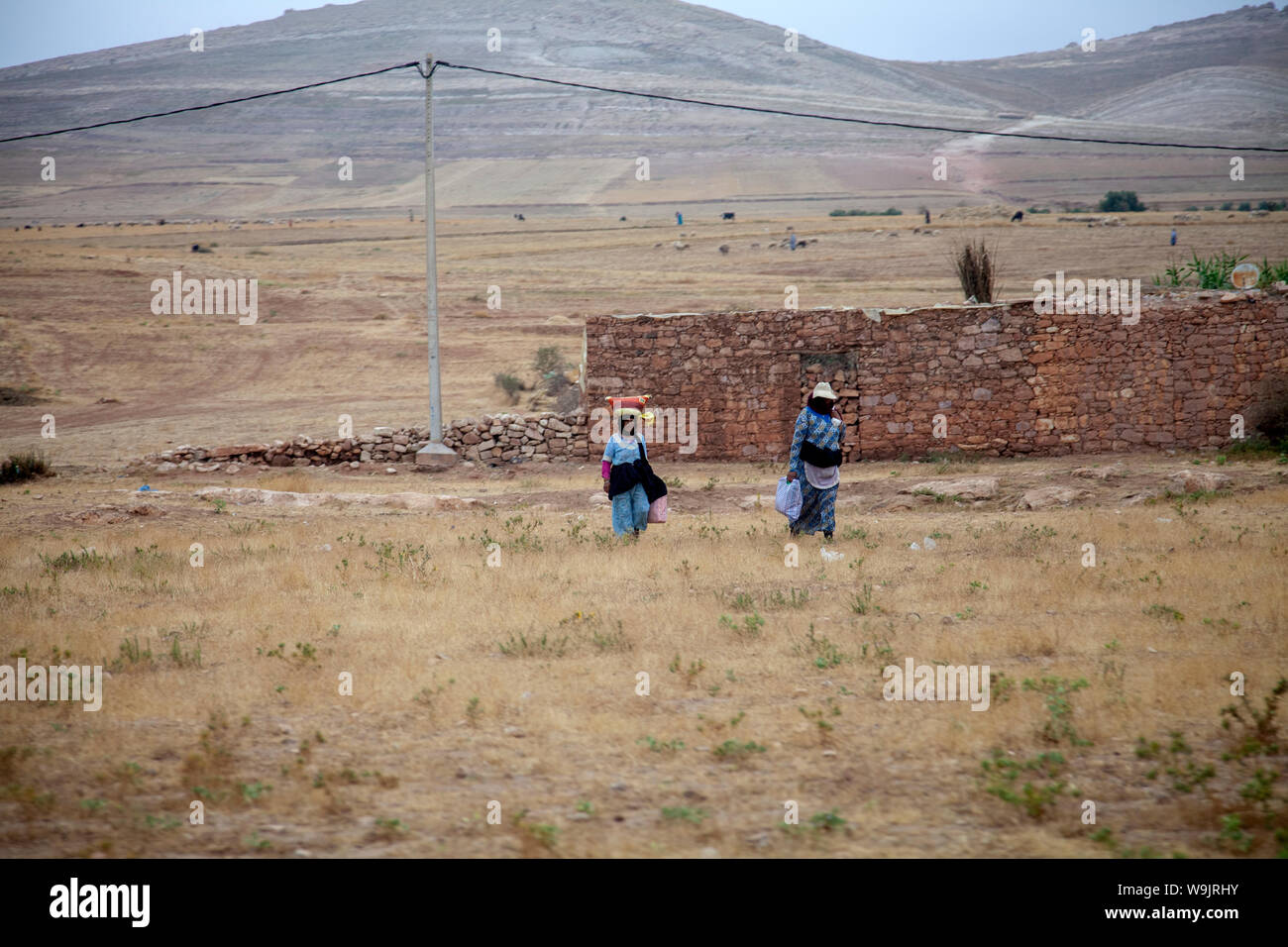 Two Women Walking on Plateau Kik  near Marrakesh in Morocco Stock Photo